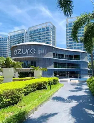 a zire office building in front of tall buildings at Azure Urban Resort Residences in Manila