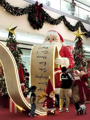 a group of children standing in front of a christmas display at Little NOAH in Manila