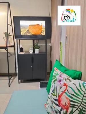 a living room with a tv and a couch at Little NOAH in Manila