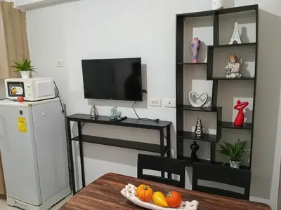 a living room with a television and a table with fruit at MP shore 1 c2 unit 1567 in Manila
