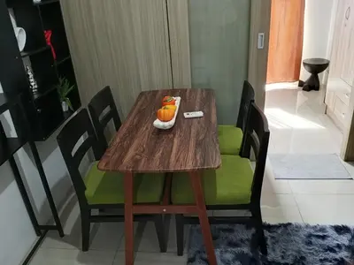 a wooden table with a bowl of oranges on it at MP shore 1 c2 unit 1567 in Manila