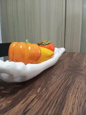two pumpkins sitting on top of a wooden table at MP shore 1 c2 unit 1567 in Manila