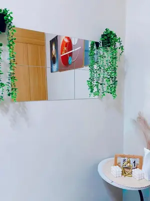 a room with a table and a potted plant at Shell Residences in Manila