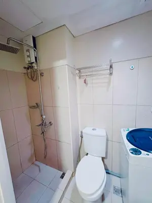 a small bathroom with a toilet and a sink at Shell Residences in Manila