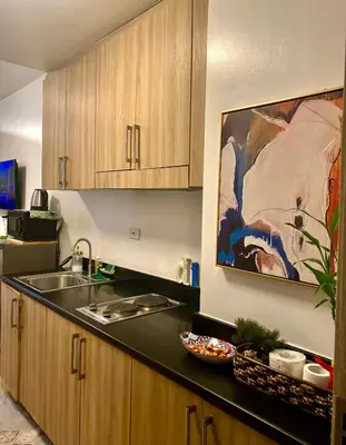 a kitchen with a sink and a counter top at Dayontabalay in Manila