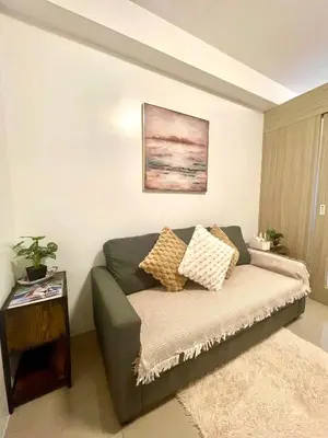 a living room with a couch and a table at Dayontabalay in Manila