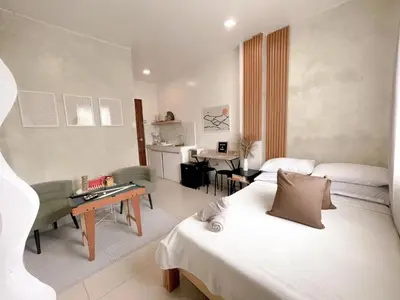 a hotel room with two beds and a living room at Boho Scandinavian with free Netflix, Wifi & Parking in Dasmariñas