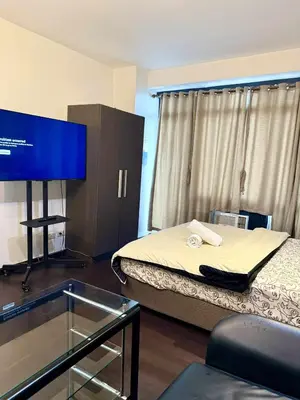 a hospital room with a bed and a tv at The Gramercy Residences in Manila
