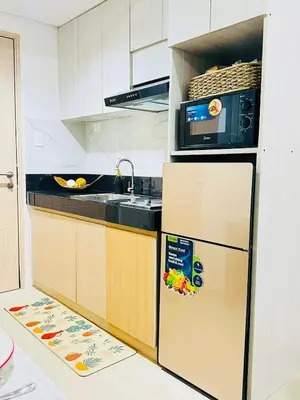 a kitchen with a refrigerator and a microwave at Family Oasis at Leaf with Netflix in Muntinlupa in Manila