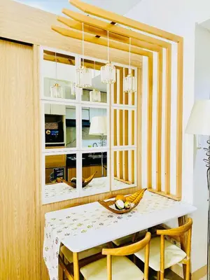a dining room with a table and a window at Family Oasis at Leaf with Netflix in Muntinlupa in Manila