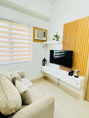 a living room with a couch and a flat screen tv at Family Oasis at Leaf with Netflix in Muntinlupa in Manila