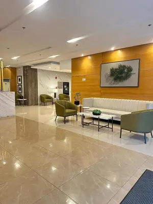 a lobby with a couch and chairs in a building at Family Oasis at Leaf with Netflix in Muntinlupa in Manila