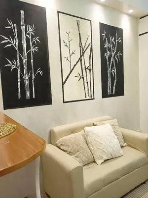 a living room with a couch and paintings on the wall at 963 D shore 1 in Manila