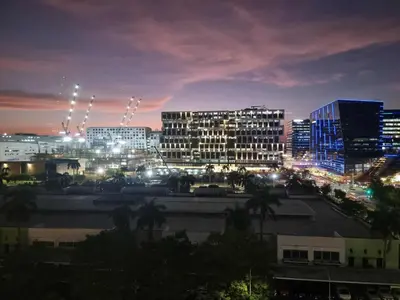 a city lit up at night with tall buildings at 963 D shore 1 in Manila