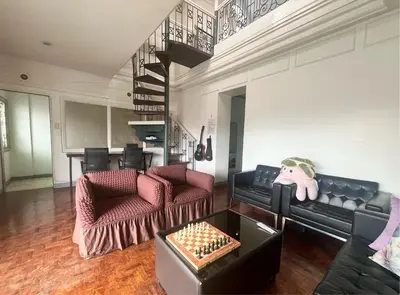 a living room with two couches and a chess board at Layover Guesthouse in Manila