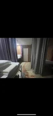 a bedroom with a bed with curtains on it at Layover Guesthouse in Manila