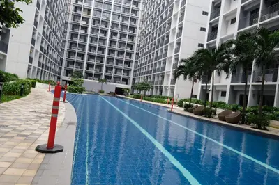 a swimming pool in front of a large building at Urban Luxe Suite - Shore 2 Residences, Steps to Mall of Asia Complex, Pasay City in Manila