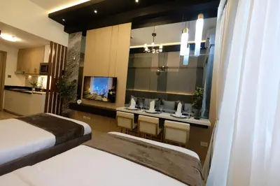 a hotel room with two beds and a sink at Urban Luxe Suite - Shore 2 Residences, Steps to Mall of Asia Complex, Pasay City in Manila