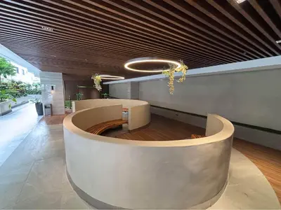 a lobby with a circular seating area in a building at Sunnyplace Residences Near NAIA Airport in Manila
