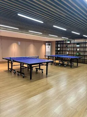 two ping pong tables in a large room at Sunnyplace Residences Near NAIA Airport in Manila