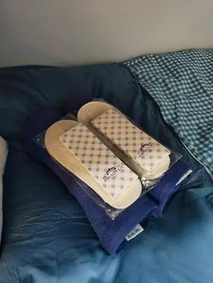 a hat on top of a pillow on a bed at Studio City Staycation in Manila
