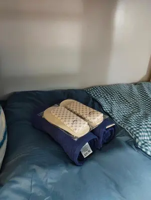 a bed with two pillows on top of it at Studio City Staycation in Manila