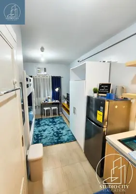 a room with a kitchen with a rug on the floor at Studio City Staycation in Manila