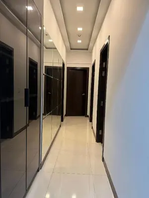 a hallway in a building with mirrors on the walls at Cozy Apartment with Private Room in Vibrant Taguig in Manila