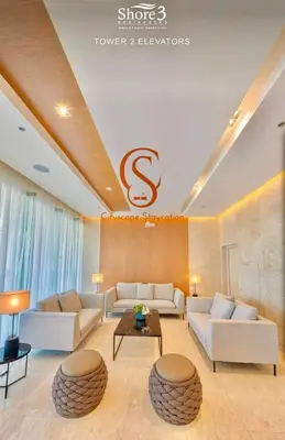 a living room with white couches and a table at Shore 3, Mall of Asia Complex in Manila