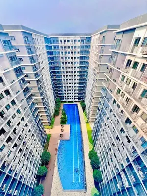 an aerial view of a large apartment building with a swimming pool at Shore 3, Mall of Asia Complex in Manila