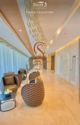 a lobby with couches and chairs in a building at Shore 3, Mall of Asia Complex in Manila