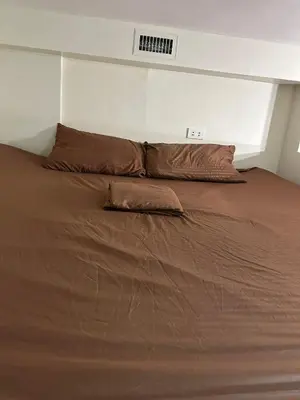 a large bed with two pillows on top of it at Cozy Loft Unit in Manila in Manila
