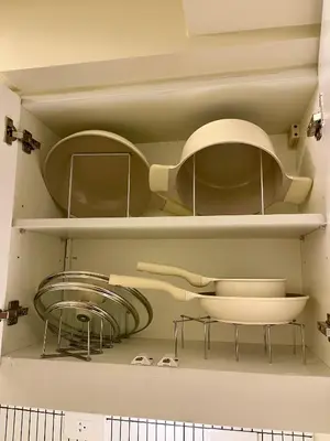 a shelf with bowls and other items on it at Balé Cù Calathea Place near airport road NAIA and MOA in Manila