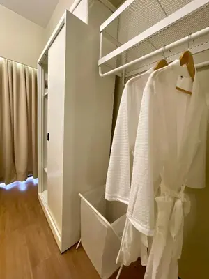 a bathroom with white towels hanging on a rack at Balé Cù Calathea Place near airport road NAIA and MOA in Manila