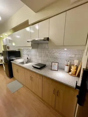 a kitchen with a sink and a refrigerator at Balé Cù Calathea Place near airport road NAIA and MOA in Manila