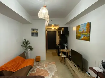 a living room with a couch and a tv at Kasara T14K Cozy Abode in Manila