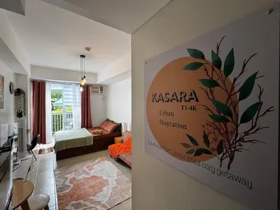 a living room with a sign on the wall at Kasara T14K Cozy Abode in Manila