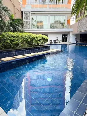 a large blue swimming pool in a building at Sunshine100PioneermMandaluyong PoolGymBilliardsPlaygroundTVWifi in Manila