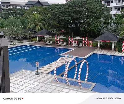 a large swimming pool with red and white swim aids at Resort Inspired Condo Beside NAIA Terminal 1 Near Okada and City of Dreams in Manila