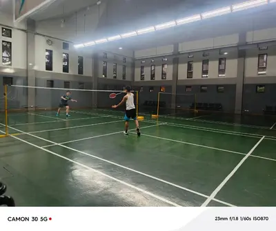 two men playing tennis on a tennis court at Resort Inspired Condo Beside NAIA Terminal 1 Near Okada and City of Dreams in Manila