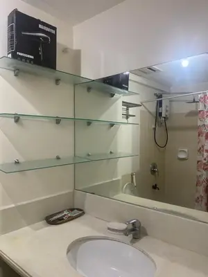 a bathroom with a sink and a mirror at Resort Inspired Condo Beside NAIA Terminal 1 Near Okada and City of Dreams in Manila