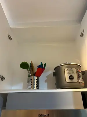 a shelf with a toaster and a pot on it at MK's place in Manila