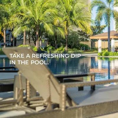 a sign that says take a refreshing dip in the pool at Condotels in Sucat Road in Manila