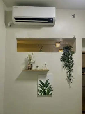 a room with a wall with two plants on it at The Azelea Suites By Azel in Manila