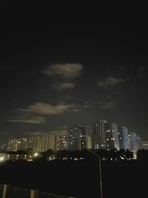 a city skyline at night with tall buildings at The Azelea Suites By Azel in Manila