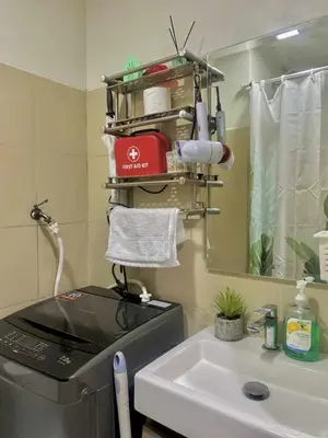 a kitchen with a sink and a stove and a mirror at The Azelea Suites By Azel in Manila