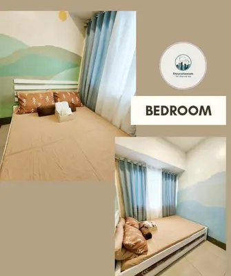a bedroom with a bed with a couch and a window at Cozy Family Suite at Fame Residences Tower 2 Mandaluyong in Manila