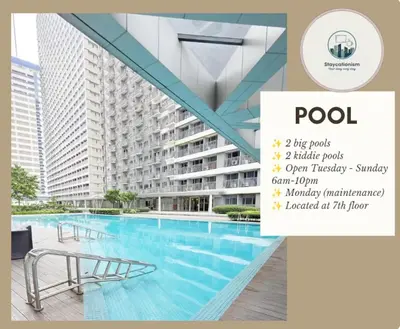 a swimming pool in front of a building at Cozy Family Suite at Fame Residences Tower 2 Mandaluyong in Manila