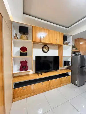 a kitchen with a large flat screen tv at Kitty Breeze Staycation in Manila