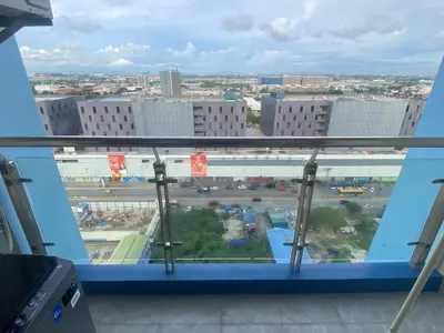 a view of a city from a window at Manila City Center Executive Apartments near Ayala Mall and PITX in Manila